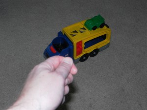 Toy truck with car on top