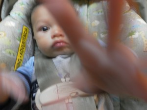 baby with hand up baby peace sign