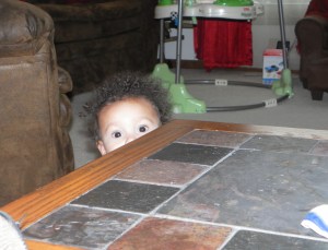 boy peering over tabletop
