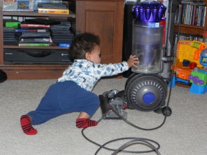 boy reaching out toward vacuum